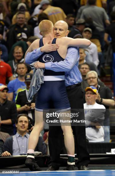 Bo Nickal of the Penn State Nittany Lions celebrates with head coach Cael Sanderson after winning the 184 pound title during the championship finals...