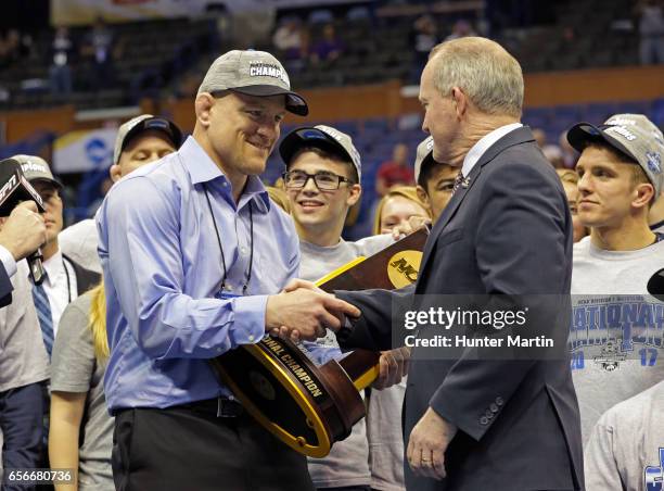 Head coach Cael Sanderson of the Penn State Nittany Lions smiles after being presented with the NCAA Wrestling National Championship team trophy...