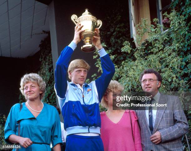Boris Becker of West Germany holds aloft the trophy, surrounded by his family, after defeating Kevin Curren of the USA during the men's singles final...
