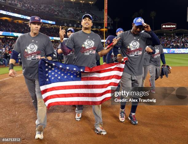 Christian Yelich, Giancarlo Stanton and Adam Jones of Team USA celebrate on field after winning Game 3 of the Championship Round of the 2017 World...