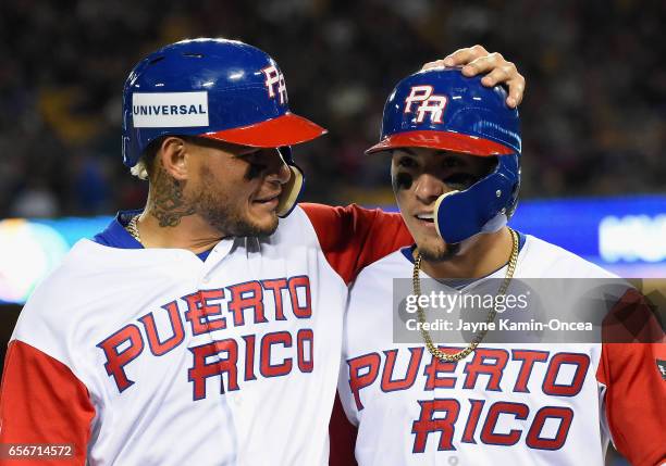 Yadier Molina and Javier Baez of team Puerto Rico walk into the dugout after both being out on a double play in the eighth inning against the United...