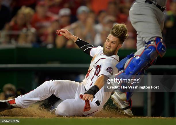 Nationals' Bryce Harper is safe at home after running all the way from 1st base on a Wilson Ramos 6th inning double as the Washington Nationals play...