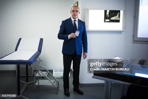 Anis Chouk foot surgeon, married with two children, lives in Yvelines, in the Paris suburbs, poses with his voting card in Poissy on March 16, 2017....