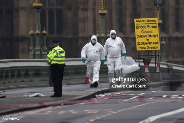 Police forensic officers work on Westminster Bridge following yesterday's attack, on March 23, 2017 in London, England. Four people have been killed...