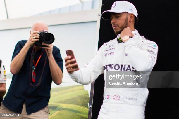 Lewis Hamilton of the United Kingdom driving for Mercedes AMG Petronas, uses his mobile phone during driver portrait session before the 2017 Formula...