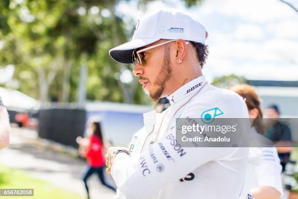 Lewis Hamilton of the United Kingdom driving for Mercedes AMG Petronas, takes off his racing suit after the driver portrait session before the 2017...