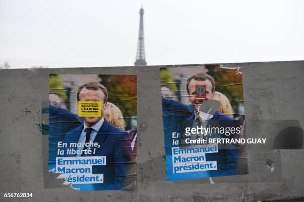 Campaign posters of French presidential election candidate for the En Marche ! movement Emmanuel Macron is seen in front of the Eiffel tower in...
