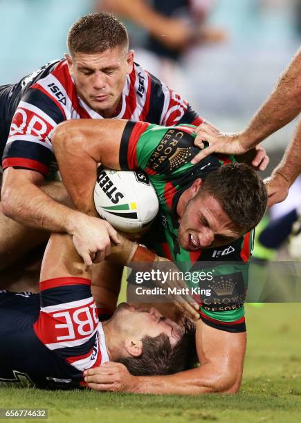 Sam Burgess of the Rabbitohs is tackled during the round four NRL match between the South Sydney Rabbitohs and the Sydney Roosters at ANZ Stadium on...