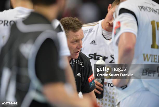 Alfred Gislason, head coach of Kiel talks with his players during the first leg round of 16 EHF Champions League match between THW Kiel and Rhein...