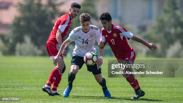 Aram Khamoyan of Armenia challenges Yannik Keitel of Germany during the UEFA U17 elite round match between Germany and Armenia on March 23, 2017 in...