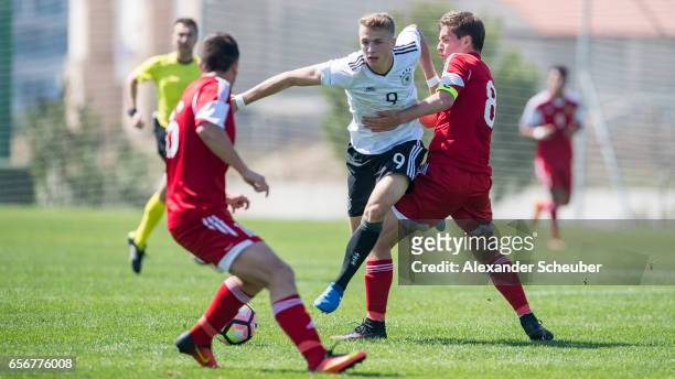 Arsen Yeghiazaryan of Armenia challenges Jann-Fiete Arp of Germany during the UEFA U17 elite round match between Germany and Armenia on March 23,...