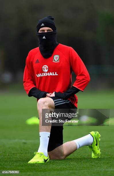 Wales player James Collins wraps up from the cold weather during a Wales Open Training session ahead of their World Cup Qualifier against the...