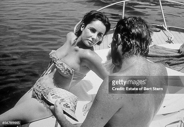 Richard Burton and Elizabeth Taylor on a boat in Ischia, Italy during filming for the barge scenes on 'Cleopatra', June 1962.
