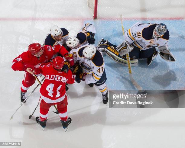 Robin Lehner of the Buffalo Sabres makes a glove save as teammates Justin Bailey, Sam Reinhart and Zach Bogosian of the Sabres battle with Luke...