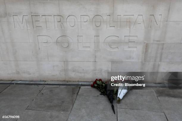 Freshly-laid flowers sit outside the New Scotland Yard headquarters of the Metropolitan Police force, laid in respect of officer Keith Palmer who...