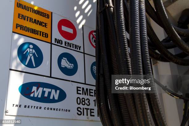 Cables used in telecommunication hang from the base station of an MTN Group Ltd. Cellular phone mast in Cape Town, South Africa, on Wednesday, March...