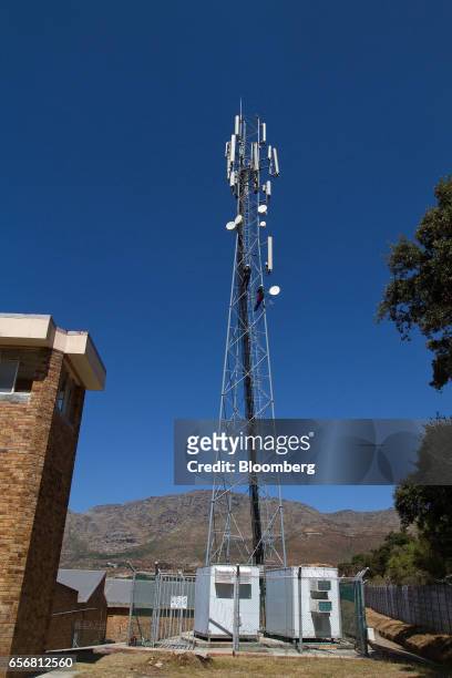Employees of CJA Telecoms perform contract maintenance work on an MTN Group Ltd. Cellular phone mast in Cape Town, South Africa, on Wednesday, March...