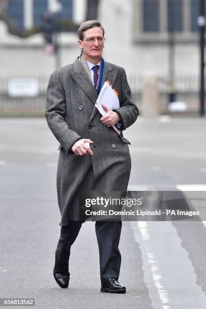 Conservative MP Dominic Grieve walks along Whitehall near the Houses of Parliament in London, after seven people were arrested in raids in London,...