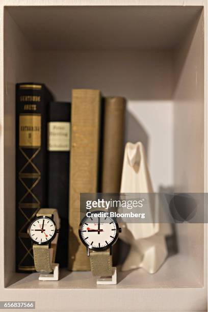 Special edition Classic official Swiss Railways model wristwatches, produced by Mondaine Watch Ltd., stand on display on a bookcase shelf at the...