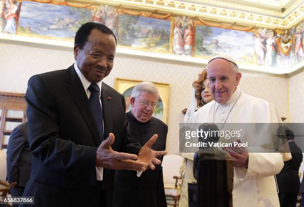 Pope Francis exchanges gifts with President of the Republic of Cameroon, Paul Biya and his wife Chantal Biya in a private audience at the Apostolic...