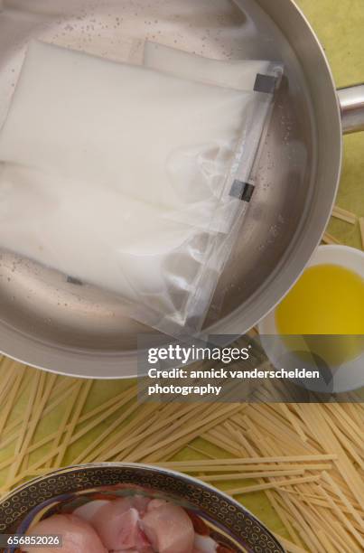 solid creamed coconut sachets warming up. - coconut chunks stock pictures, royalty-free photos & images