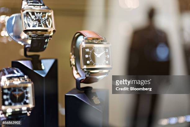 New Retro model luxury wristwatch, right, produced by De Grisogono SA, stands on display during the 2017 Baselworld luxury watch and jewelry fair in...