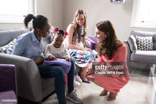 Catherine, Duchess of Cambridge meets a mother, Kirsty Francois and her daughter Teegan-Mia during a meeting with a parent support group at the...