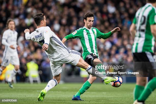 Cristiano Ronaldo of Real Madrid fights for the ball with Ruben Pardo Gutierrez of Real Betis during their La Liga match between Real Madrid and Real...