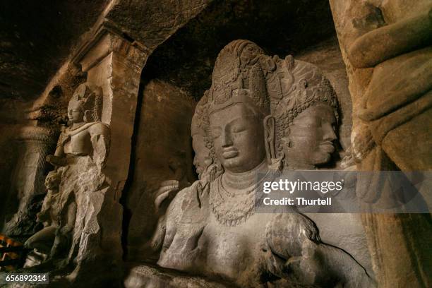 statues, shiva caves, elephanta island, mumbai, india - elephanta caves stock pictures, royalty-free photos & images