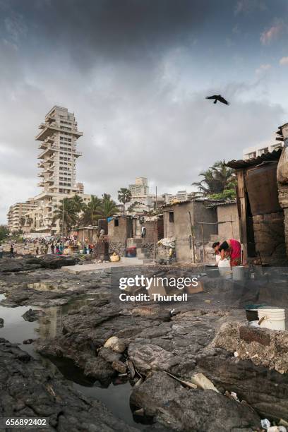 woman preparing meal in beachfront slum, mumbai, india - indian slums stock pictures, royalty-free photos & images