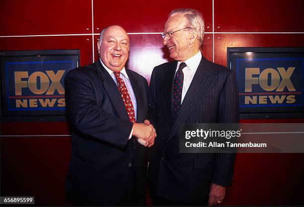 Rupert Murdoch shakes hands with Roger Ailes after naming Ailes the head of Fox News, New York, New York, January 30, 1996.