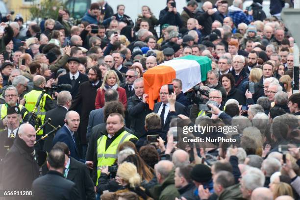 The coffin of former Northern Ireland Deputy First Minister Martin McGuinness in procession in the Bogside neighbourhood of Derry on its way to St....