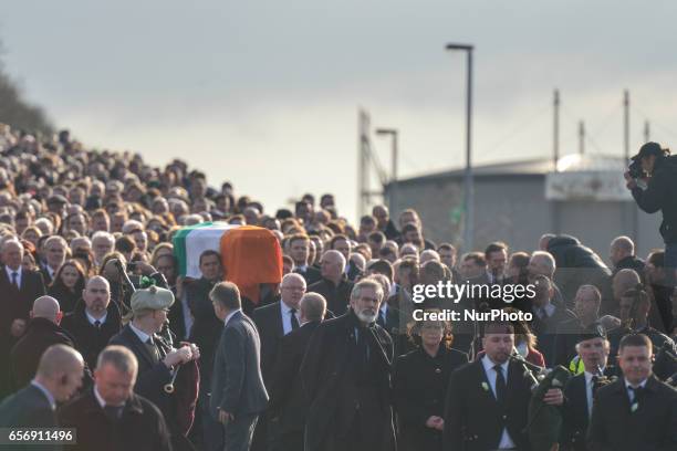 The coffin of former Northern Ireland Deputy First Minister Martin McGuinness in procession in the Bogside neighbourhood of Derry on its way from St....