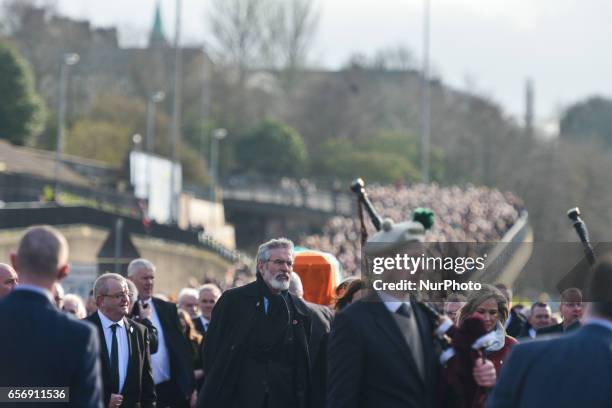 Sinn Fein President Gerry Adams walks in front of the coffin of former Northern Ireland Deputy First Minister Martin McGuinness in procession in the...