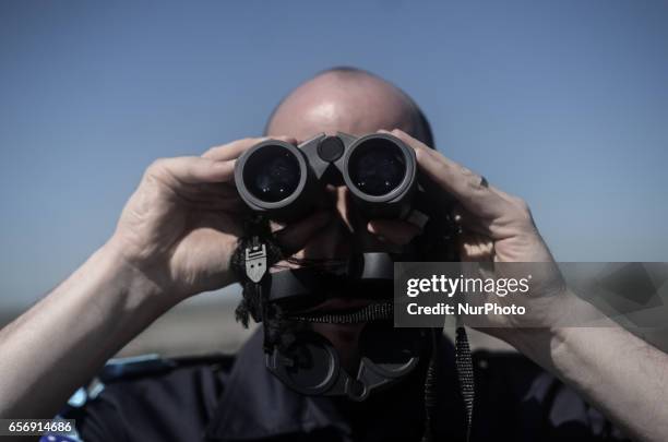 Member of the German federal police looking through his binocle, while on patrol along the Bulgaria - Turkish border, near Kapitan Andreevo border...