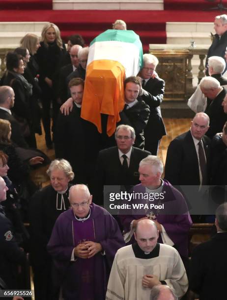 The sons of Northern Ireland's former deputy first minister and ex-IRA commander Martin McGuinness, Emmet and Fiachra , carry his coffin out of at St...
