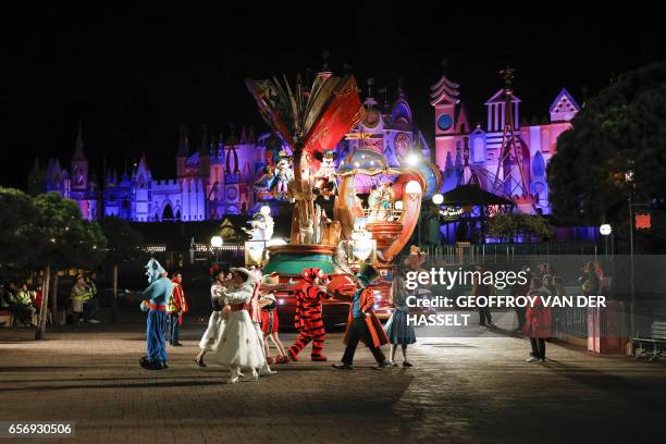 Dancers wearing Disney characters costumes take part in a night rehearsal of the Disney Stars on Parade on March 20, 2017 ahead of celebrations...