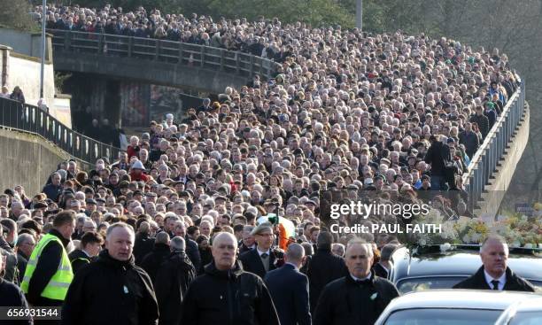 The coffin of former Northern Ireland Deputy First Minister Martin McGuinness is carried through the Bogside area of Derry, for burial at the City...