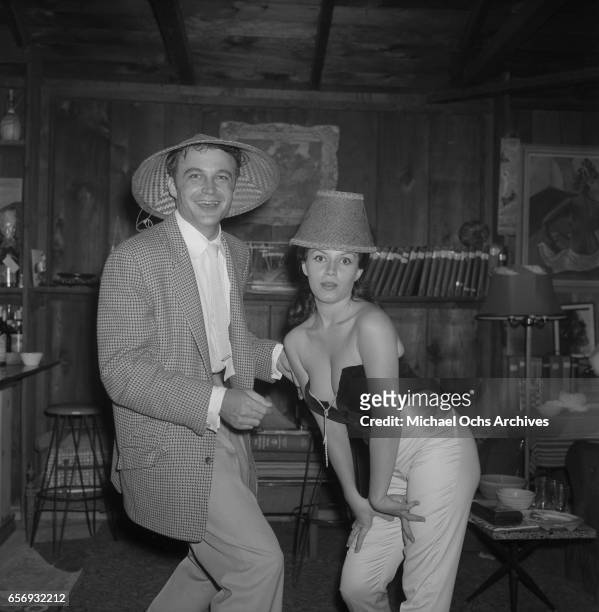 Actor Lance Fuller and actress Joan Bradshaw attend a party in honor of Playboy Magazine founder and publisher Hugh Hefner on June 26, 1957 in Los...