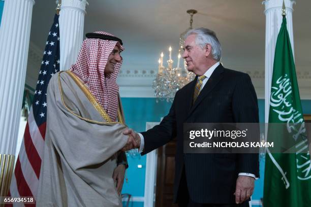 Secretary of State Rex Tillerson speaks with Saudi Foreign Minister Adel al-Jubeir prior to a meeting at the State Department in Washington, DC, on...