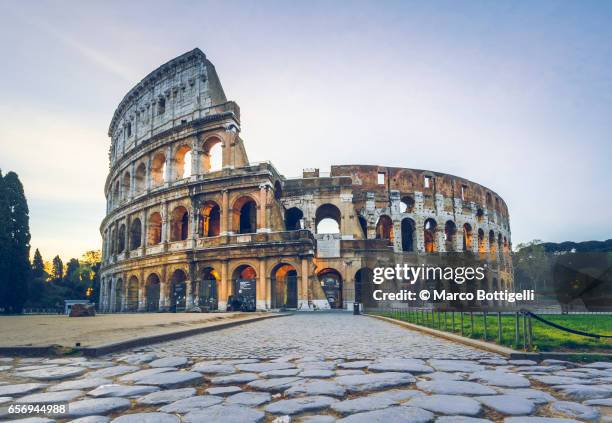 colosseum (colosseo) and via sacra. rome, italy. - coliseo romano fotografías e imágenes de stock