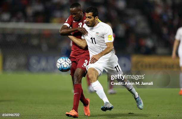 Vahid Amiri of Iran and Yasir Isa of Qatar in action during Qatar against Iran - FIFA 2018 World Cup Qualifier on March 23, 2017 in Doha, Qatar.