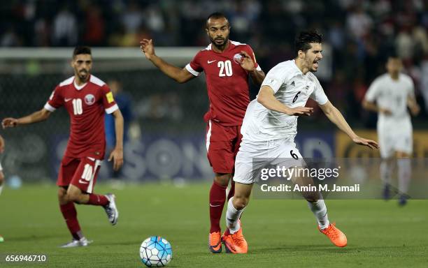 Saeid Ezatolahi of Iran and Ali Hassan Afif of Qatar in action during Qatar against Iran - FIFA 2018 World Cup Qualifier on March 23, 2017 in Doha,...