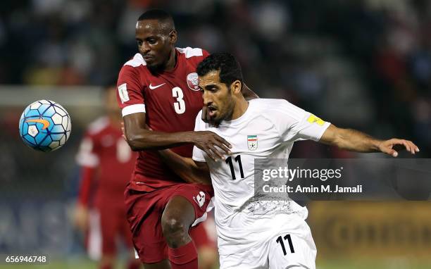 Vahid Amiri of Iran and Yasir Isa of Qatar in action during Qatar against Iran - FIFA 2018 World Cup Qualifier on March 23, 2017 in Doha, Qatar.