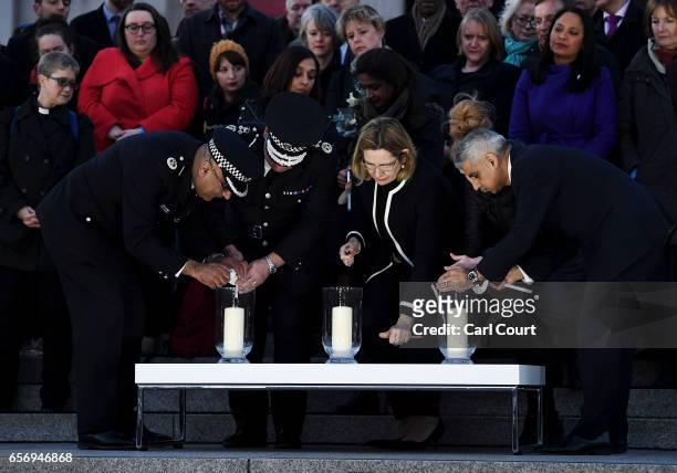 Acting Commissioner of the Metropolitan Police Craig Mackey, Home Secretary Amber Rudd MP and Mayor of London Sadiq Khan light candles during a...