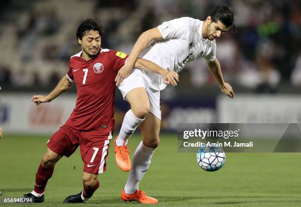 Saeid Ezatolahi of Iran and Rodrigo Tabata of Qatar in action during Qatar against Iran - FIFA 2018 World Cup Qualifier on March 23, 2017 in Doha,...