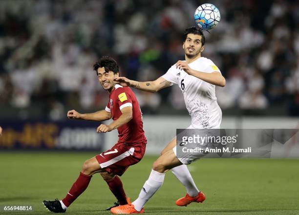 Saeid Ezatolahi of Iran and Rodrigo Tabata of Qatar in action during Qatar against Iran - FIFA 2018 World Cup Qualifier on March 23, 2017 in Doha,...