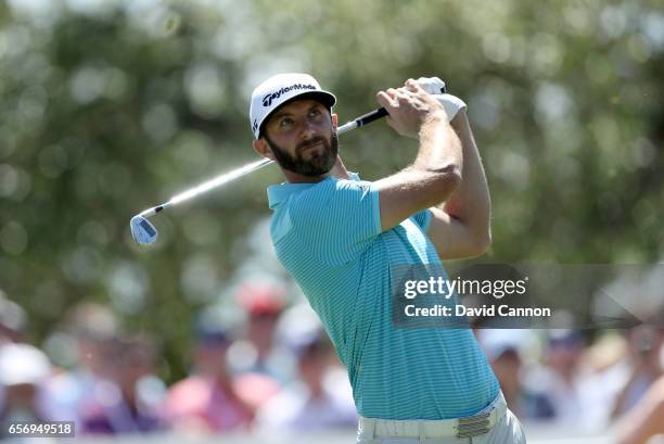 Dustin Johnson of the United States plays his tee shot on the par 3, seventh hole in his match against Martin Kaymer during the second round of the...