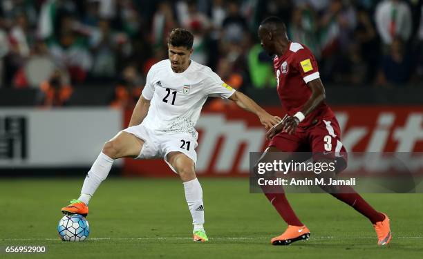 Vorya Ghafouri of iran and Yasir Isa of Qatar in action during Qatar against Iran - FIFA 2018 World Cup Qualifier on March 23, 2017 in Doha, Qatar.