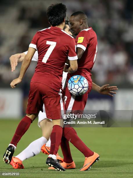 Yasir Isa and Rodrigo Tabata of Qatar in action during Qatar against Iran - FIFA 2018 World Cup Qualifier on March 23, 2017 in Doha, Qatar.